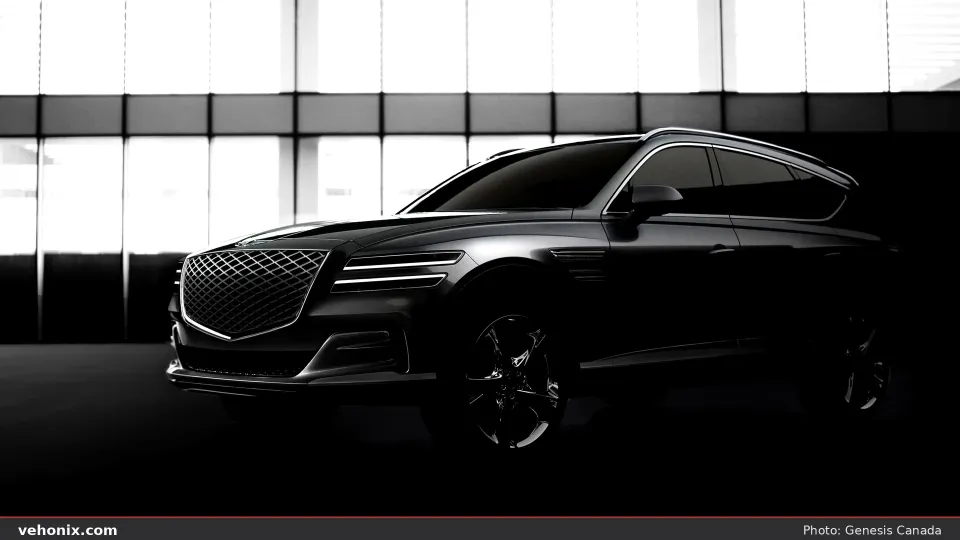 2026 Genesis GV80 in dark paint, front three-quarter in dramatic studio lighting