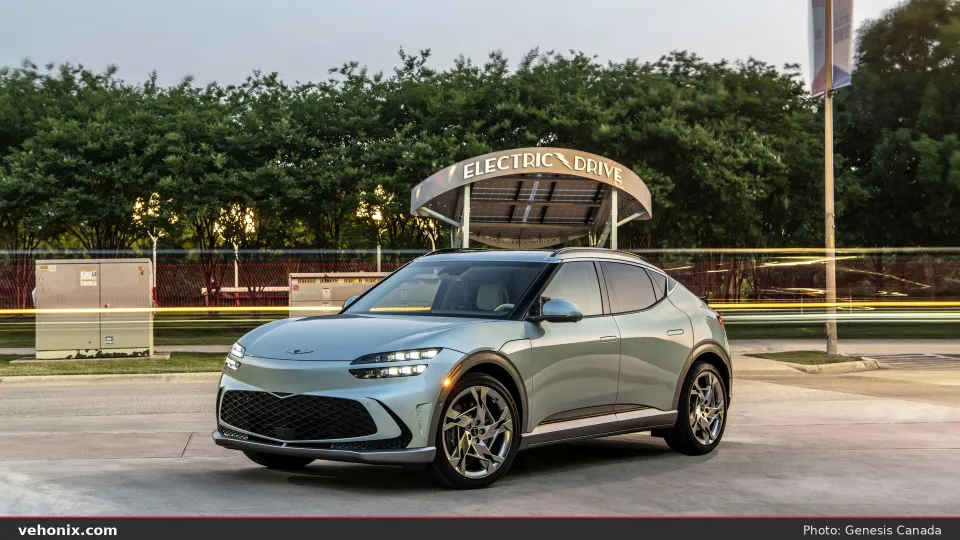 2026 Genesis GV60 Advanced in blue-silver, front three-quarter at dusk outdoors