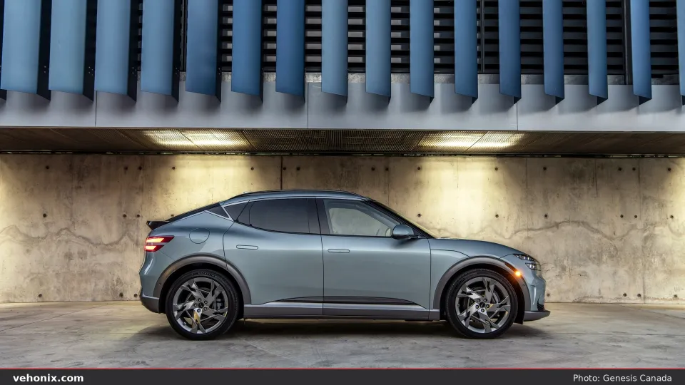 2026 Genesis GV60 in light blue, full side profile in a concrete gallery