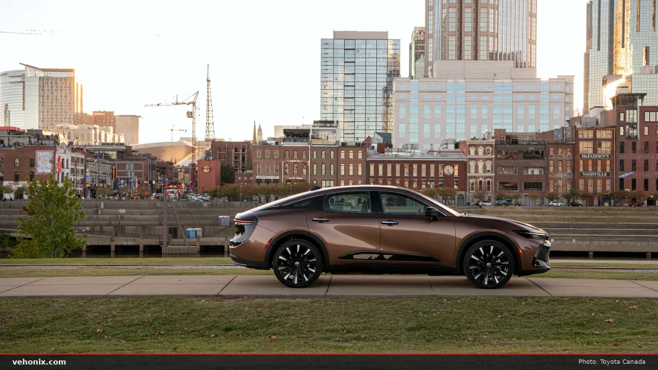 2026 Toyota Crown Platinum in bronze two-tone, side view with a city skyline