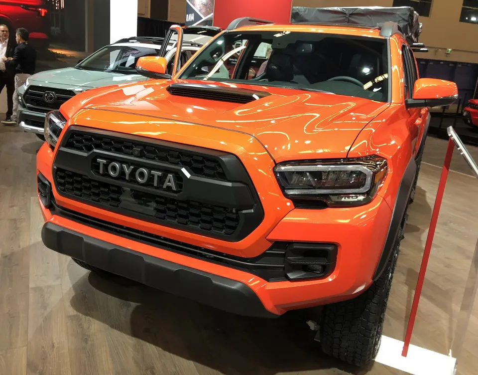 An orange Toyota Tacoma TRD Pro pickup on display at the 2023 Montreal auto show