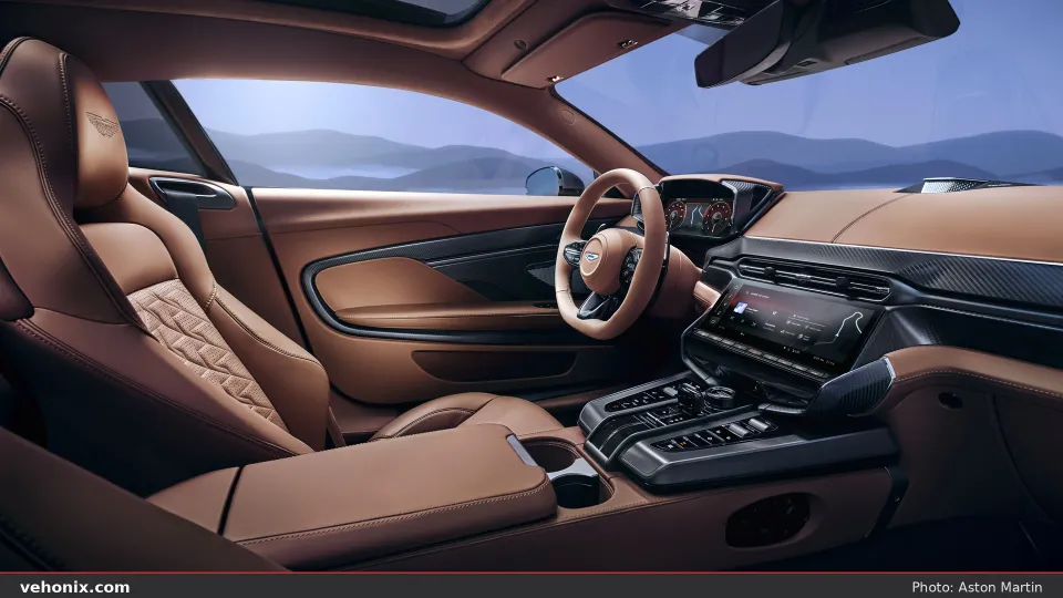 2026 Aston Martin Vanquish cabin with tan quilted leather seats and carbon-fibre trim