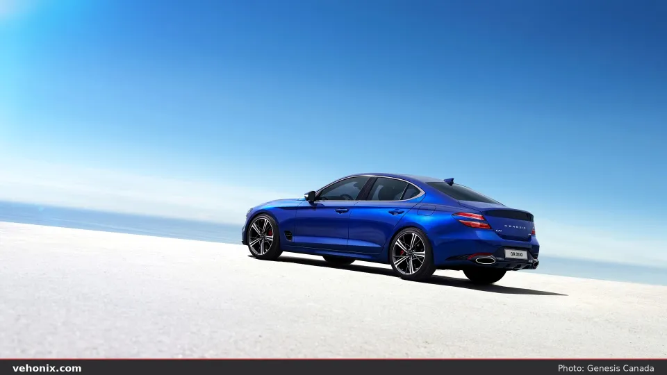 2026 Genesis G70 in bright blue, rear three-quarter on a white studio floor