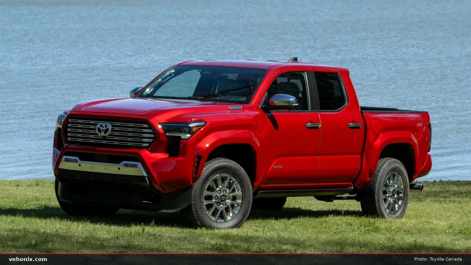 2026 Toyota Tacoma Limited in Supersonic Red, front three-quarter view on grass