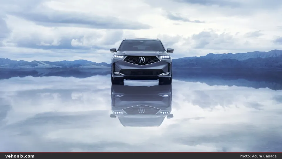 2026 Acura MDX SH-AWD front view reflected on a calm lake surface