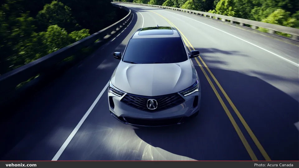 2026 Acura RDX SH-AWD A-SPEC in grey, front three-quarter view on a curving road