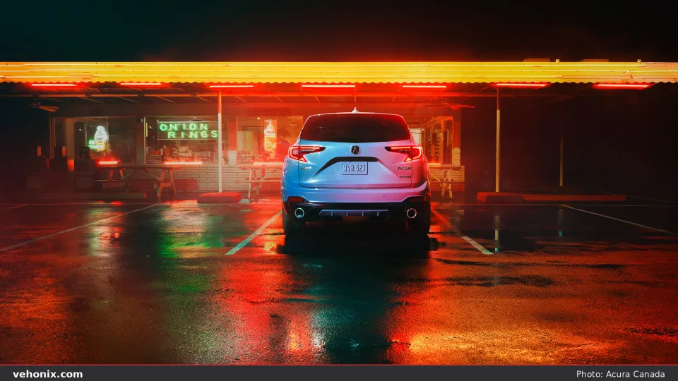 2026 Acura RDX SH-AWD A-SPEC rear view at night under neon lights