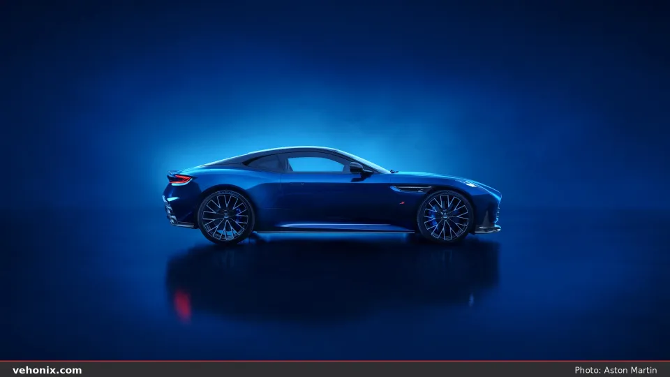 2026 Aston Martin DB12 S in dark blue, side profile on a reflective studio floor