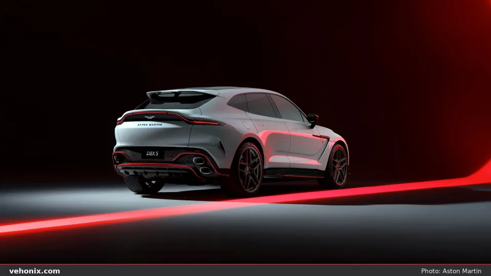 2026 Aston Martin DBX S in white, rear three-quarter studio view with red floor light