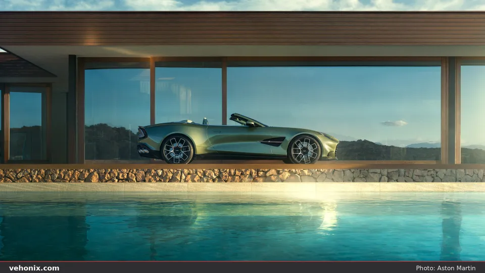 2026 Aston Martin Vanquish Volante in sage green, side profile by a pool and modern villa