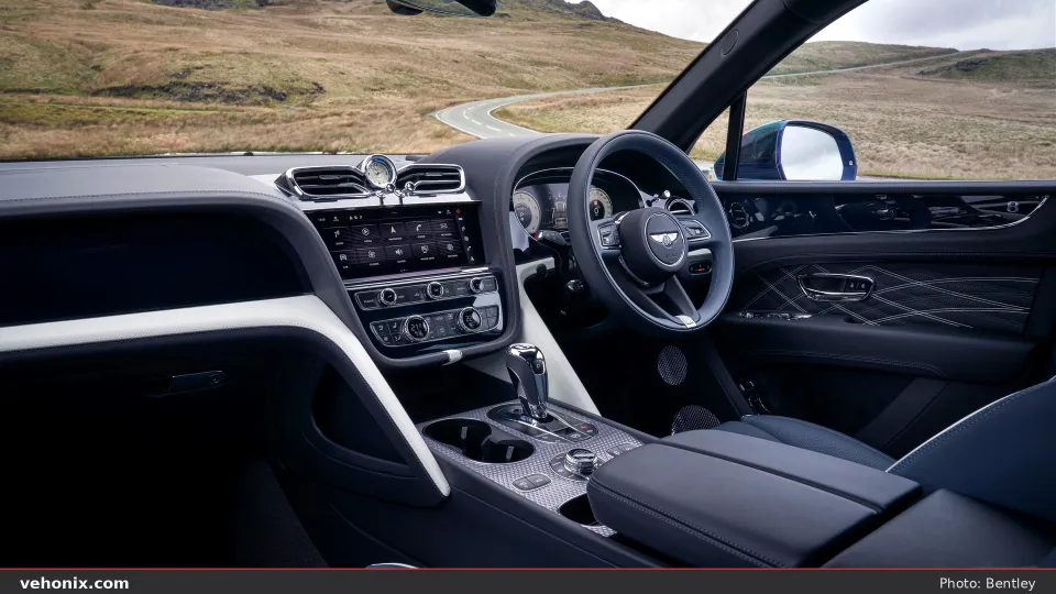 2026 Bentley Bentayga EWB cockpit with navy and white leather and Breitling clock