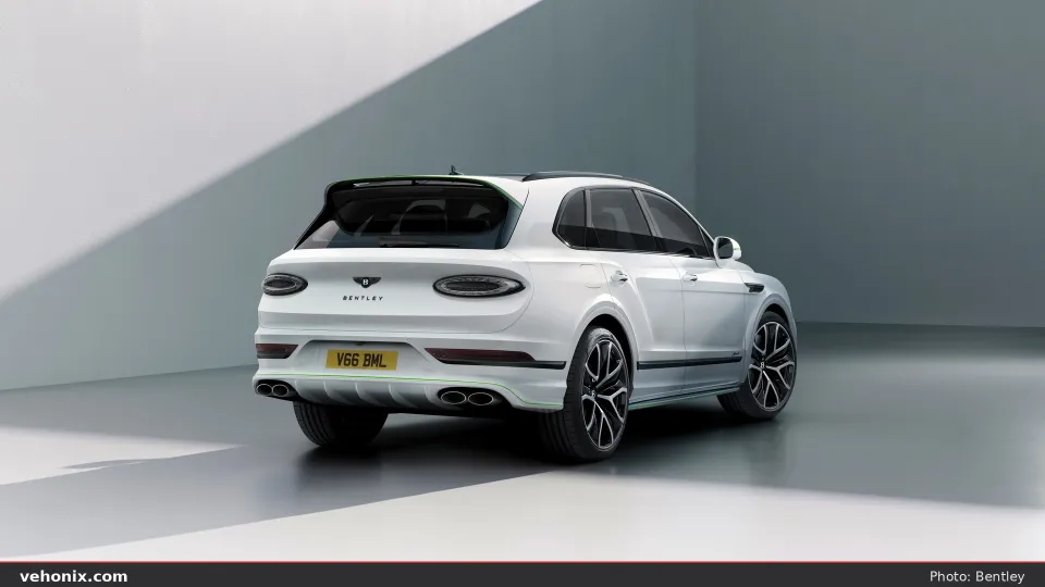 2026 Bentley Bentayga in white, rear three-quarter studio view with oval exhausts
