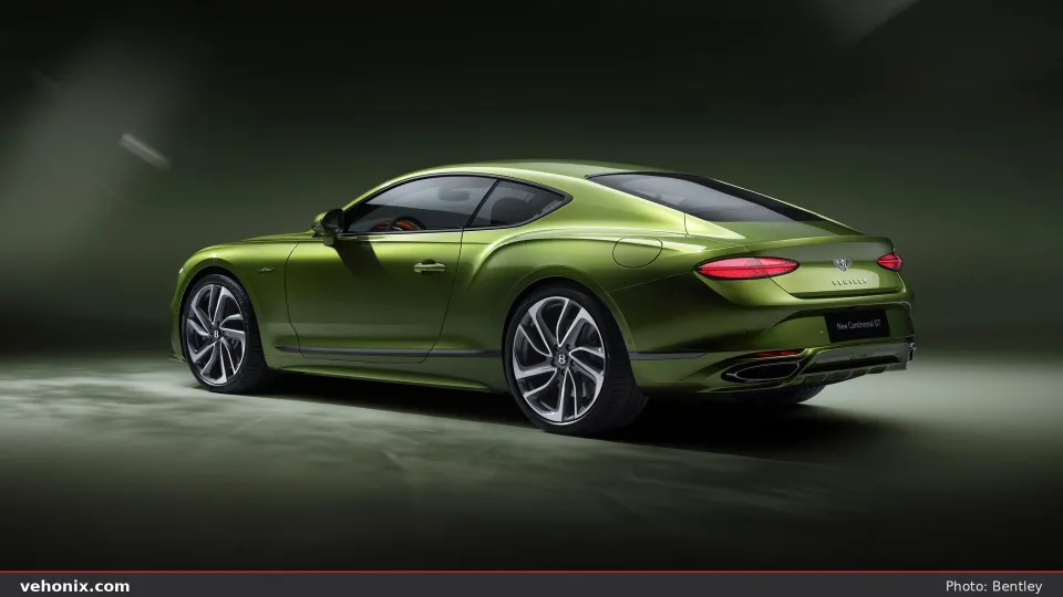 2026 Bentley Continental GT in metallic green, rear three-quarter studio view