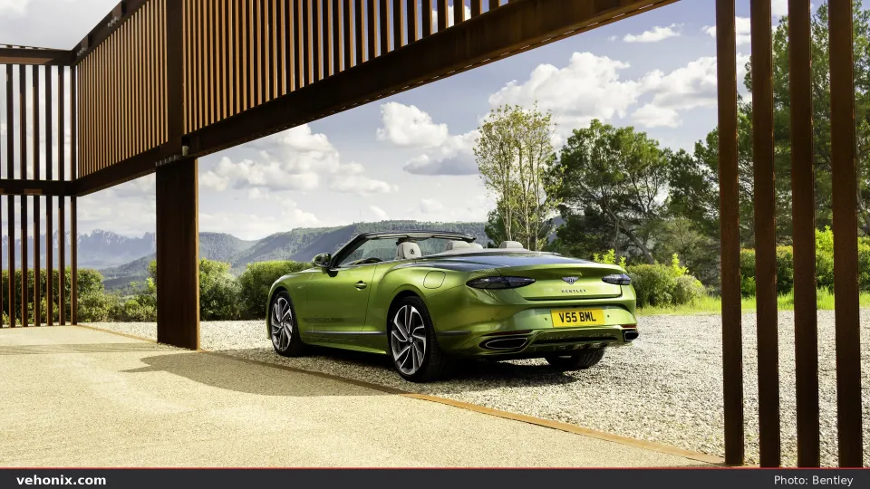 2026 Bentley Continental GT Convertible in green, rear three-quarter with top down