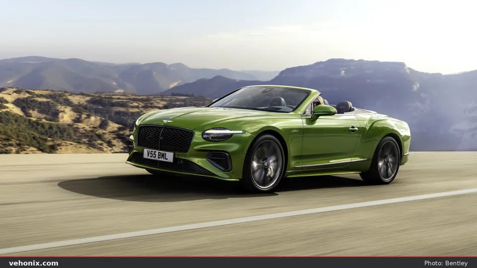 2026 Bentley Continental GT Convertible in green, front three-quarter driving top-down