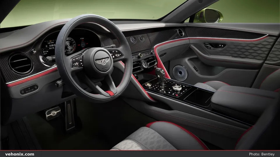 2026 Bentley Flying Spur cockpit with dark grey leather, carbon trim and red accents
