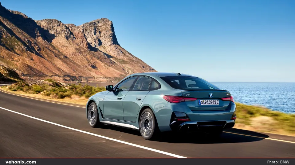 2026 BMW i4 M60 xDrive Gran Coupe in red, exterior view