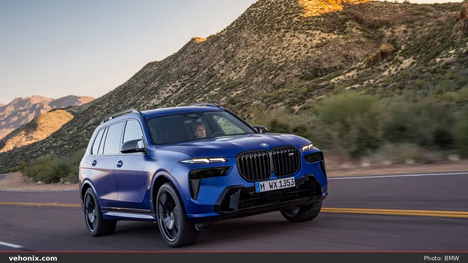 2026 BMW X7 M60i xDrive in orange, exterior view