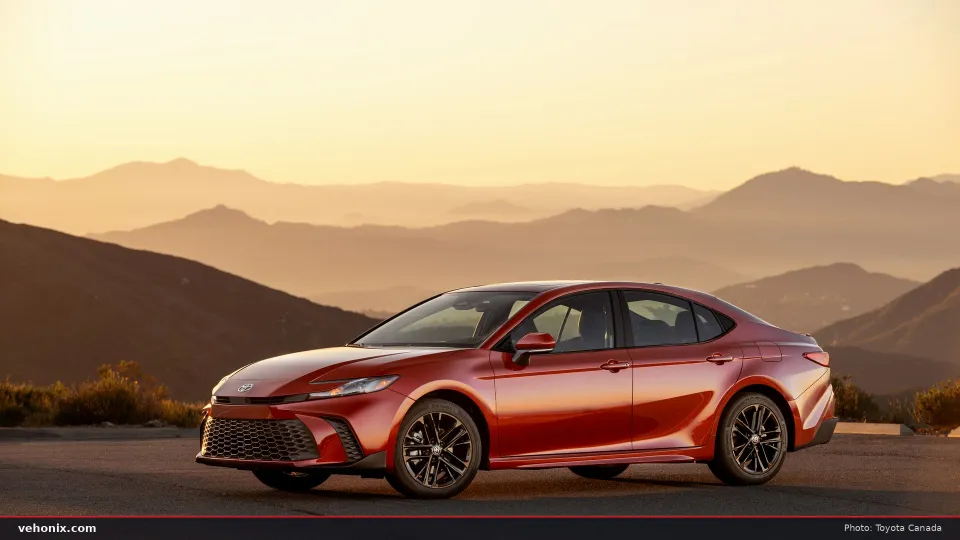 Toyota Camry SE AWD hybrid sedan in Supersonic Red