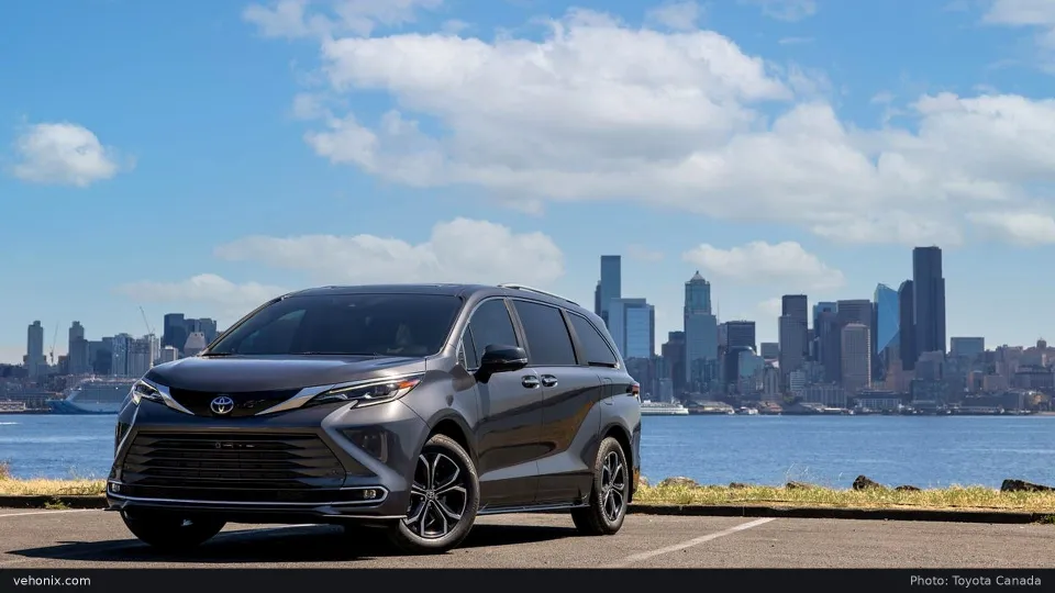 2026 Toyota Sienna Platinum in grey, front three-quarter view with a city skyline