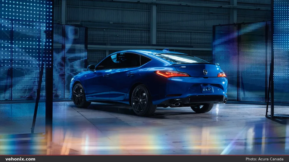 2026 Acura Integra A-SPEC in blue, rear three-quarter view in a lit studio