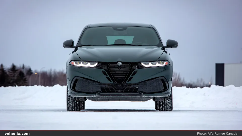 2026 Alfa Romeo Tonale Sprint in dark green, straight-on front view in winter setting
