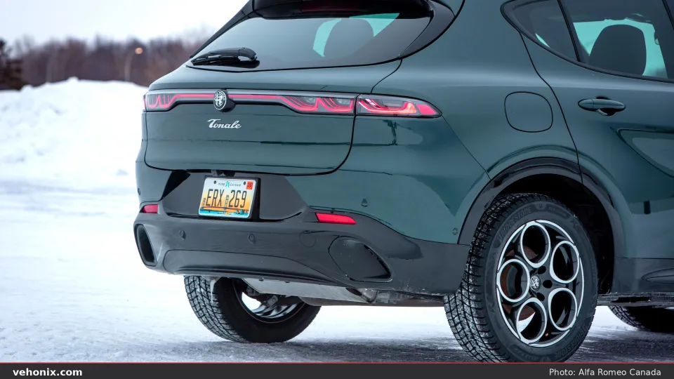 2026 Alfa Romeo Tonale Sprint in dark green, rear three-quarter view on snow