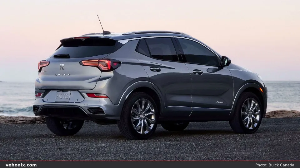 2026 Buick Encore GX Avenir in gray, rear three-quarter by the ocean at dusk