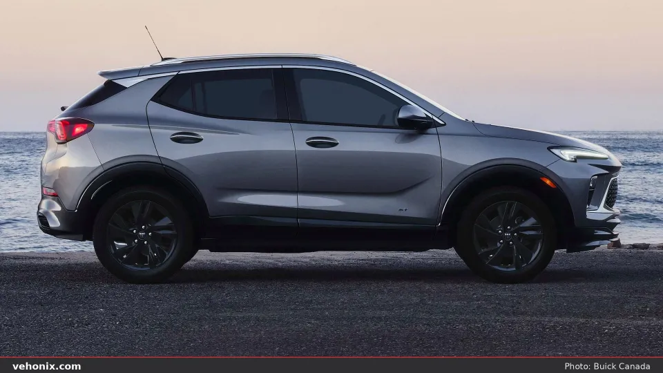 2026 Buick Encore GX ST in gray, full side profile by the water at dusk