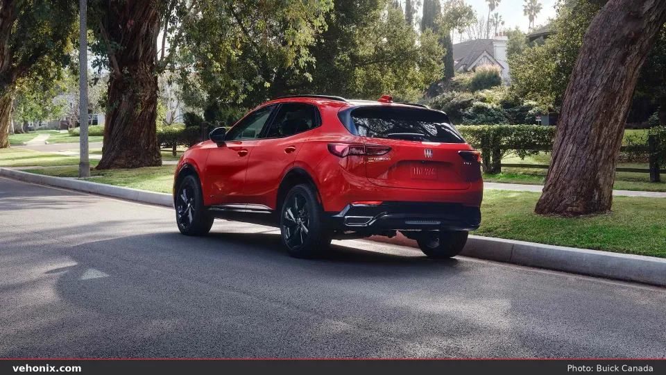 2026 Buick Envision in red, rear three-quarter parked on a residential street