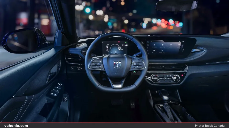 2026 Buick Envista cockpit at night with dual digital displays and blue ambient light