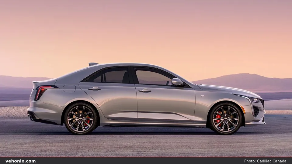 2026 Cadillac CT4 in silver, full side profile against a desert sunrise