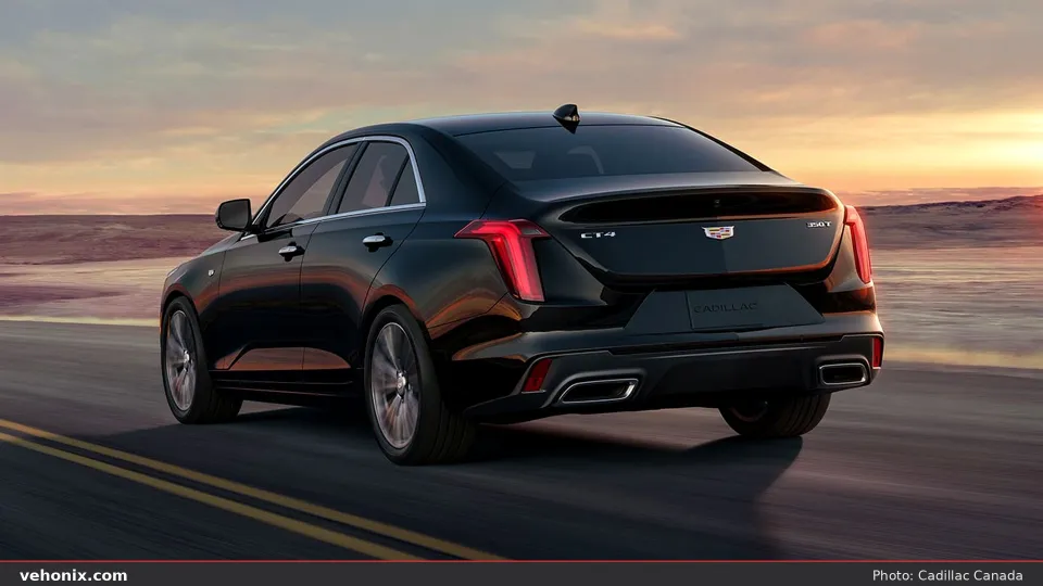 2026 Cadillac CT4 in black, rear three-quarter driving at sunset
