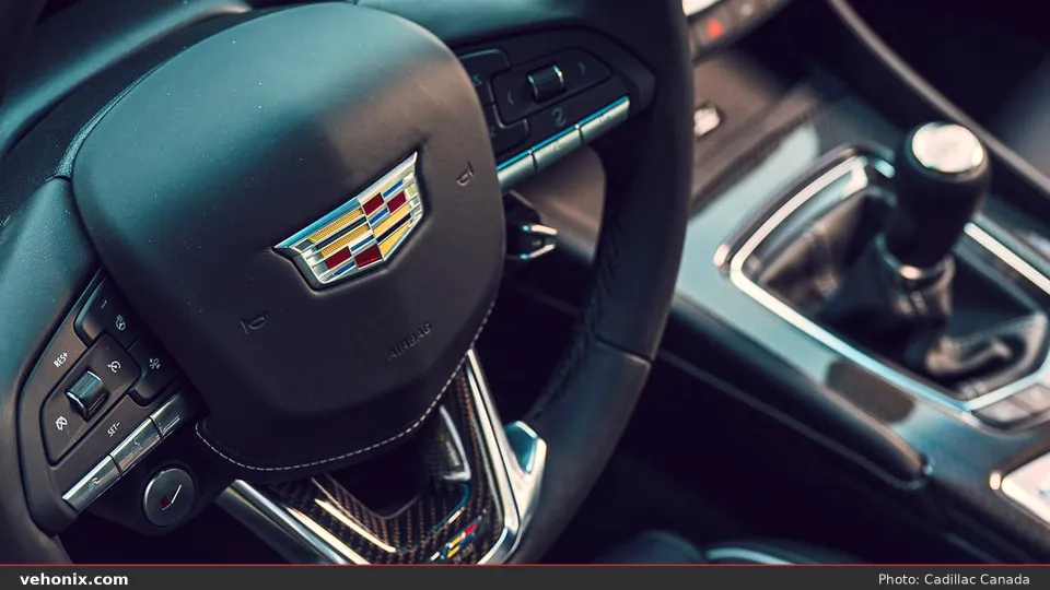 2026 Cadillac CT4-V steering wheel crest and carbon-fiber console with manual shifter
