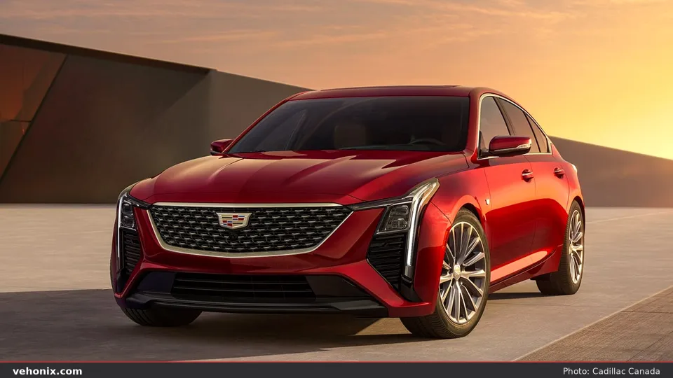 2026 Cadillac CT5 in red, front three-quarter parked in warm sunset light