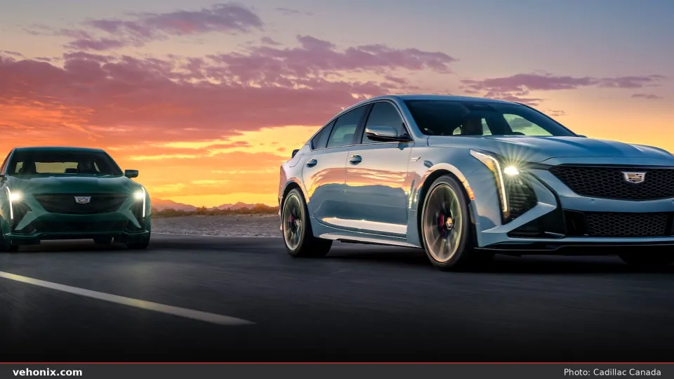 2026 Cadillac CT5-V pair in blue and green driving at sunset on open road