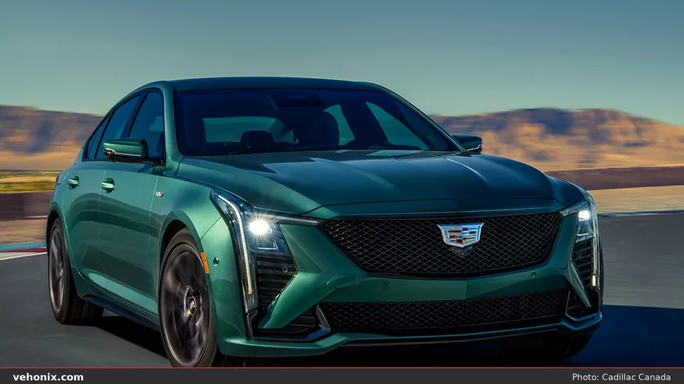2026 Cadillac CT5-V in emerald green, front three-quarter driving in desert hills