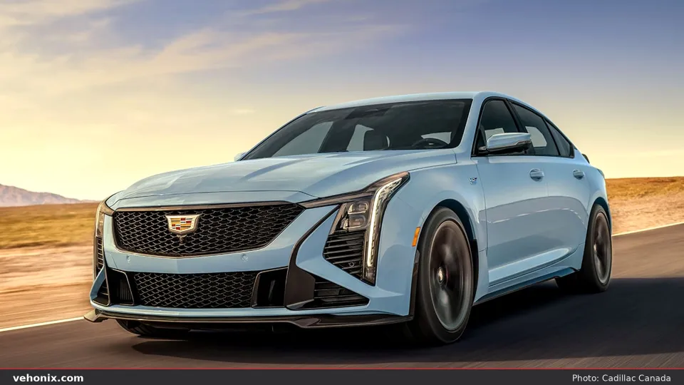 2026 Cadillac CT5-V in light blue, front three-quarter driving through desert scrub