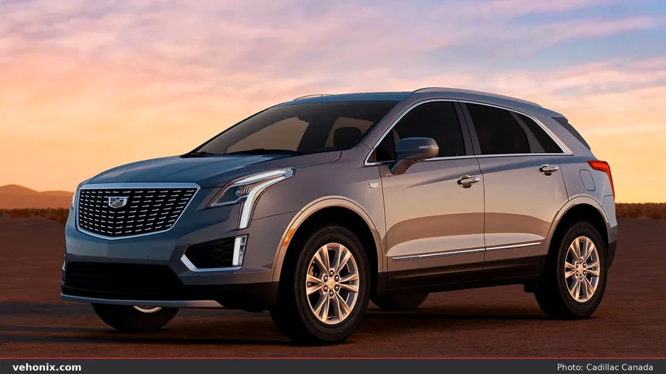 2026 Cadillac XT5 in silver, front three-quarter in a desert at golden hour
