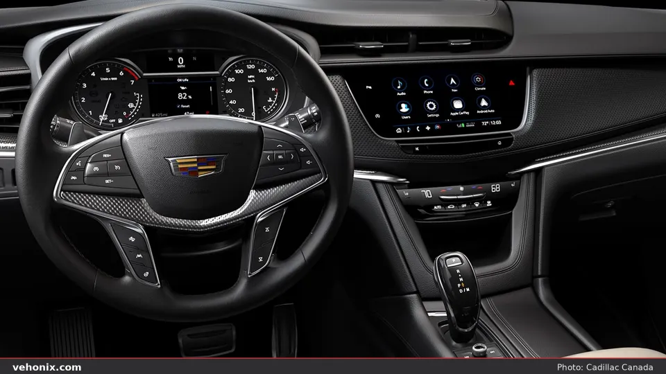 2026 Cadillac XT5 cockpit with touchscreen, climate strip and carbon-look trim