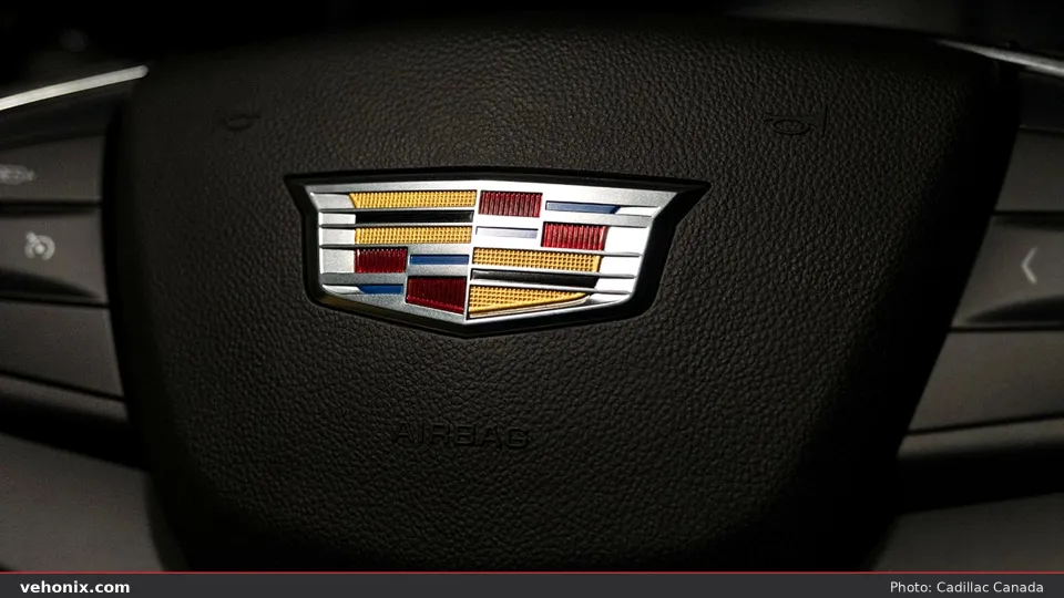 2026 Cadillac XT5 steering-wheel close-up with colored Cadillac crest emblem