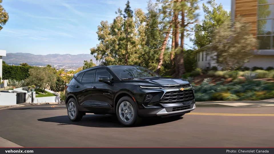 2026 Chevrolet Blazer in black, front three-quarter driving on a hillside road