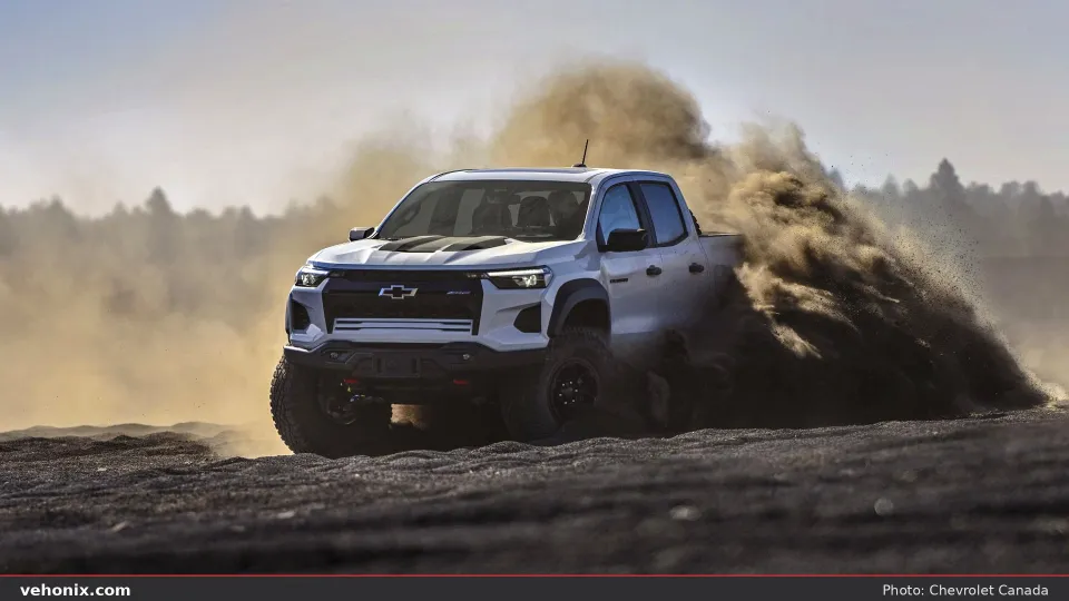 2026 Chevrolet Colorado Mud Terrain in silver, front view kicking up dirt