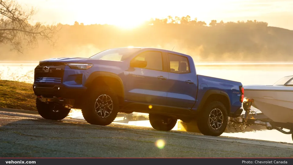 2026 Chevrolet Colorado ZR2 Bison in blue, front three-quarter view towing a boat