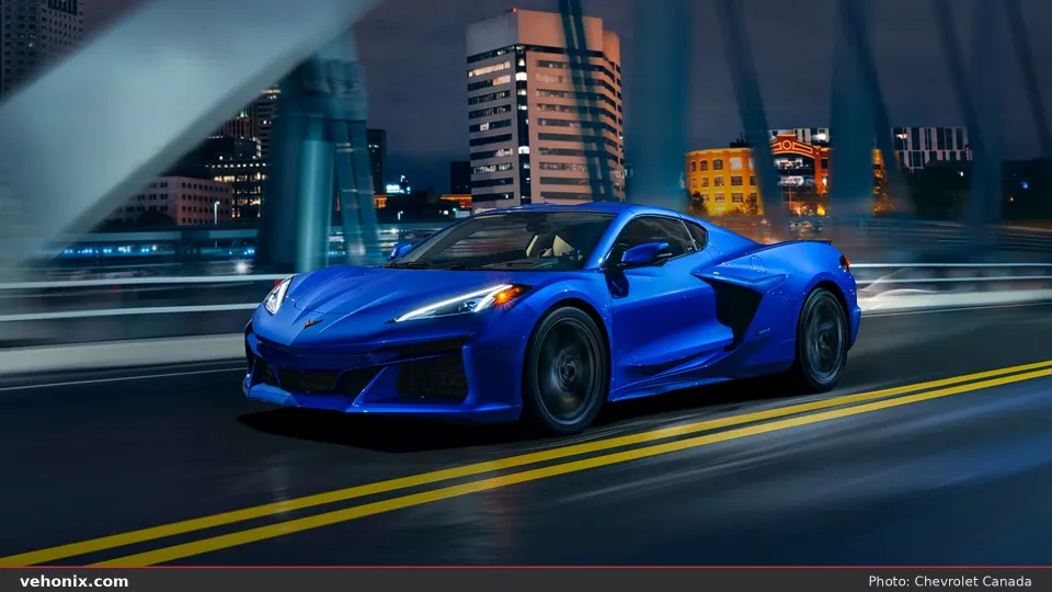 2026 Chevrolet Corvette E-Ray in blue, front three-quarter view at night