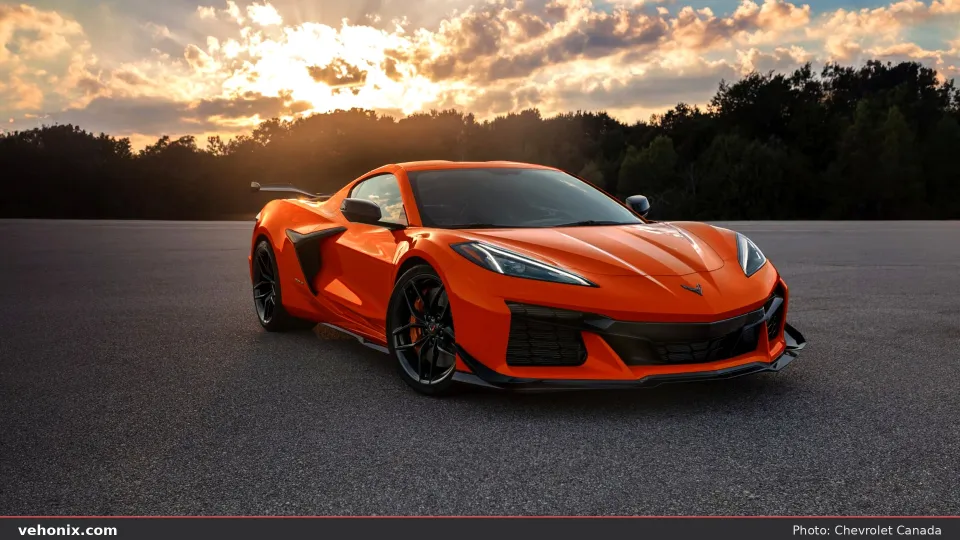 2026 Chevrolet Corvette Z06 in orange, front three-quarter at sunset