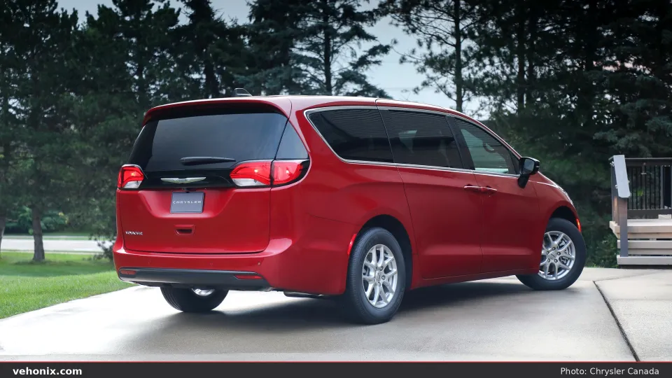 2026 Chrysler Grand Caravan in red, rear three-quarter on a driveway