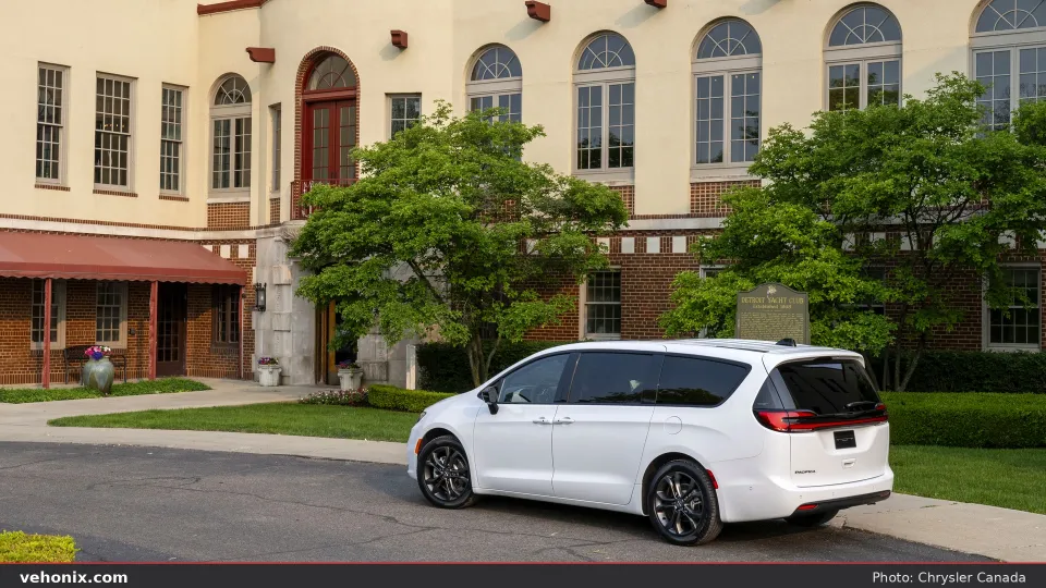 2026 Chrysler Pacifica in white, rear three-quarter outside a historic clubhouse