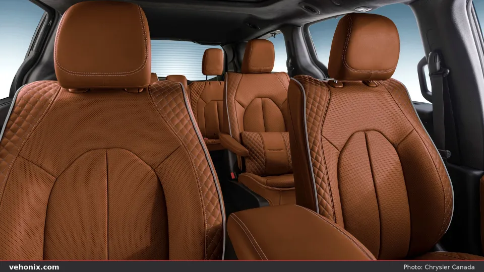 2026 Chrysler Pacifica cabin looking aft at quilted caramel leather captain’s chairs