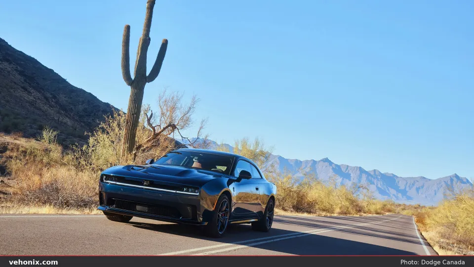2026 Dodge Charger Daytona Scat Pack in dark blue, rear three-quarter on a desert road